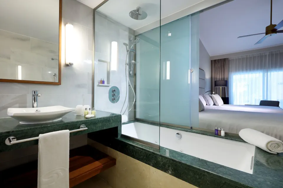 Deluxe Garden View bathroom and king bed at Grand Palladium Punta Cana Resort & Spa.