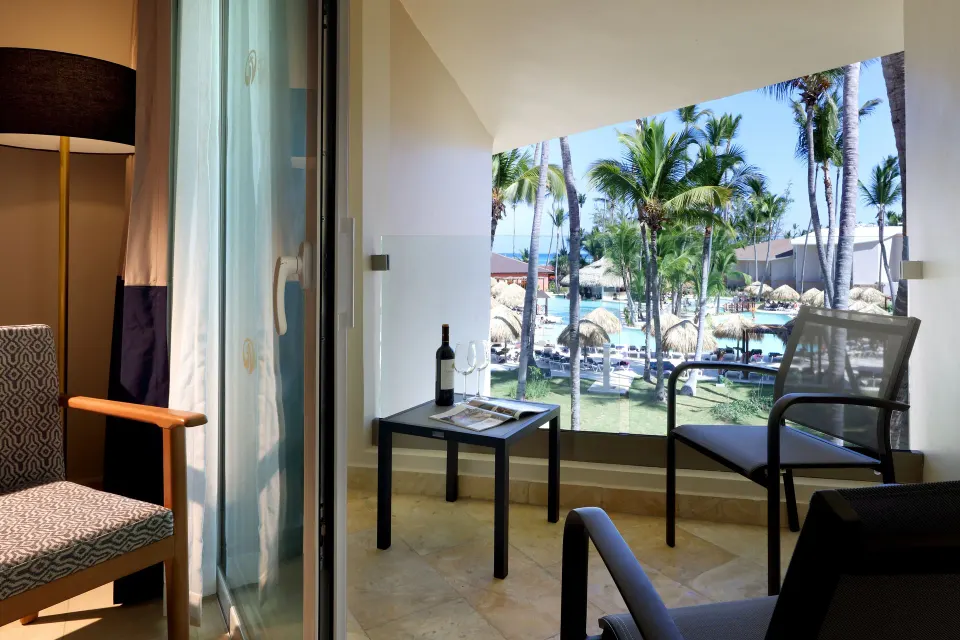 Junior Suite Poolside balcony overlooking pools and palms at Grand Palladium Punta Cana Resort & Spa.