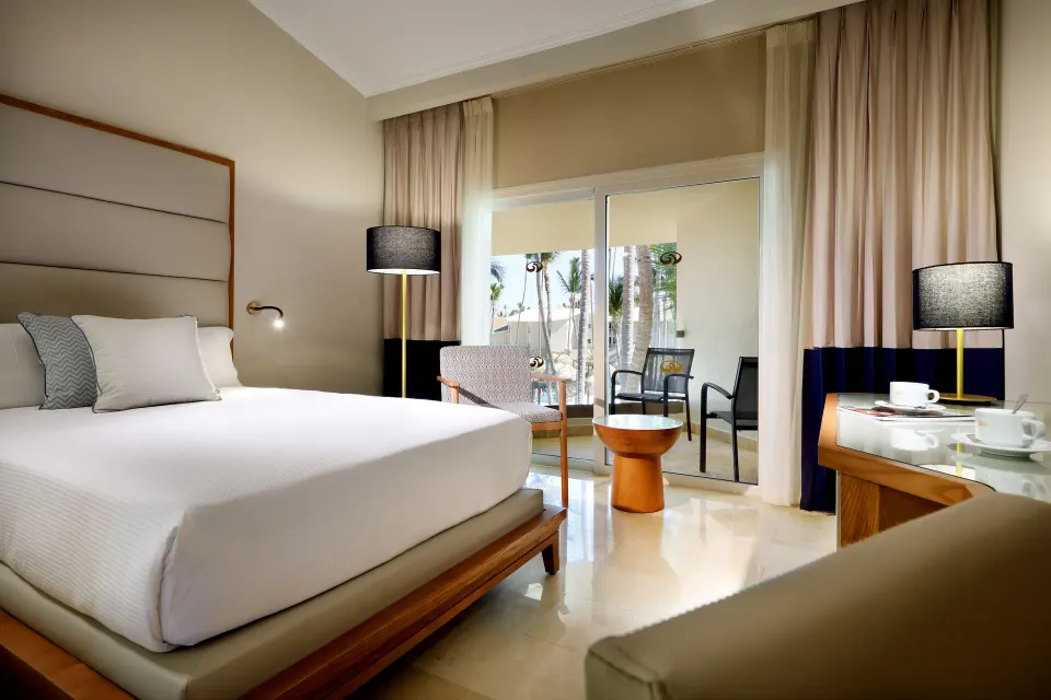 Junior Suite Poolside bed and balcony seating at Grand Palladium Punta Cana Resort & Spa.