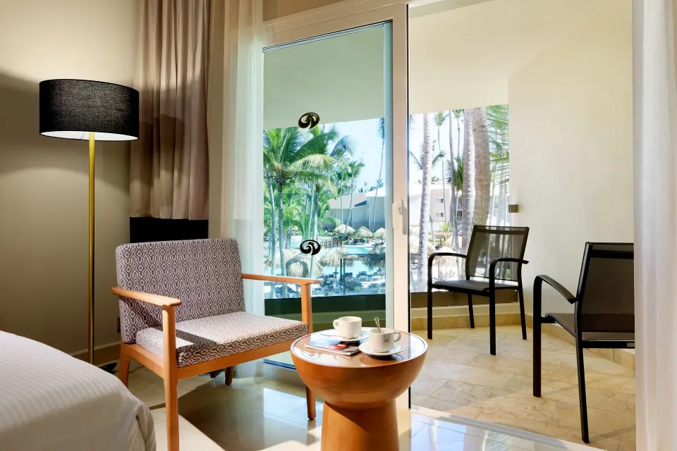 Junior Suite Poolside sitting area by balcony doors at Grand Palladium Punta Cana Resort & Spa.