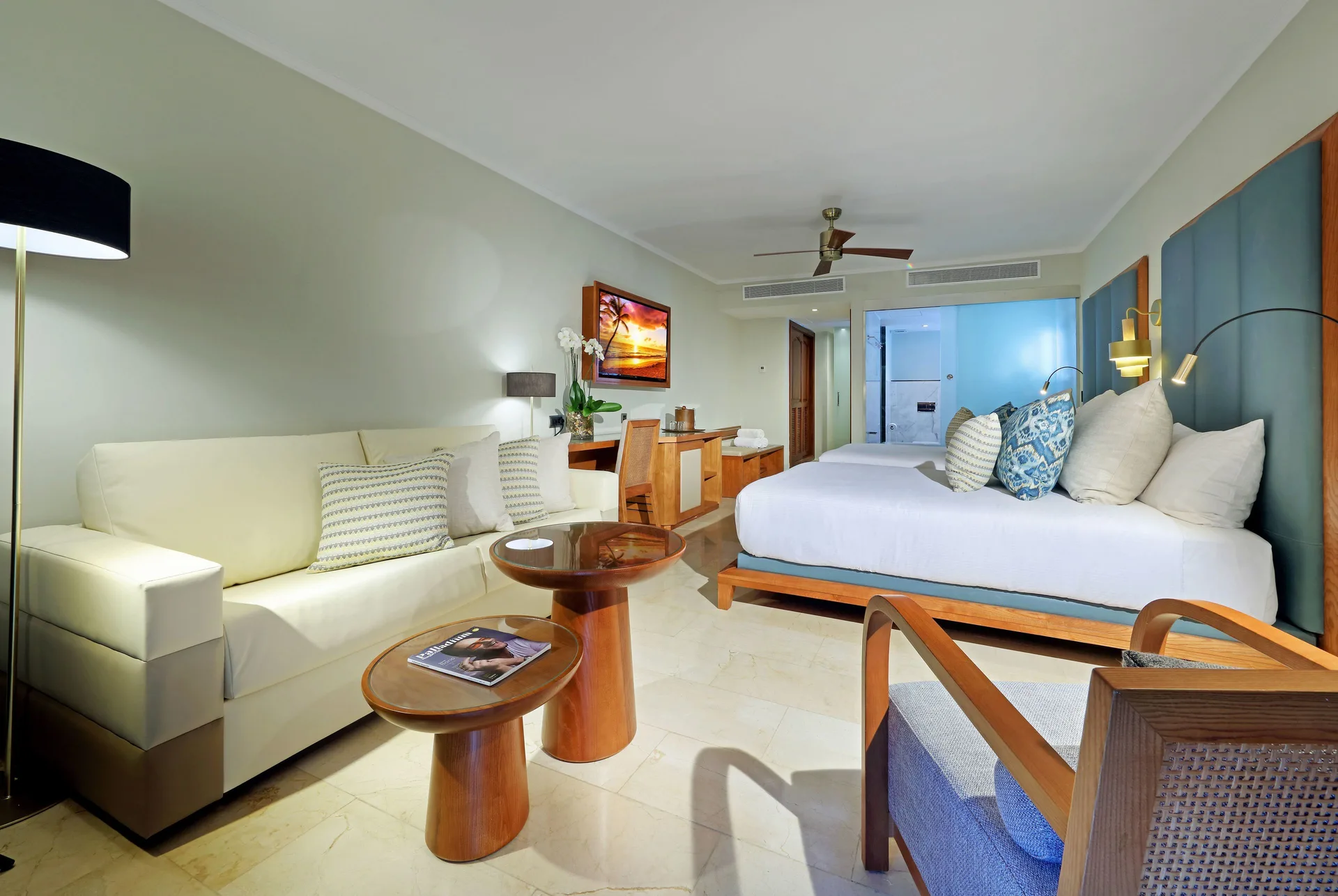 Junior Suite Poolside room with king bed and sofa at Grand Palladium Punta Cana Resort & Spa.
