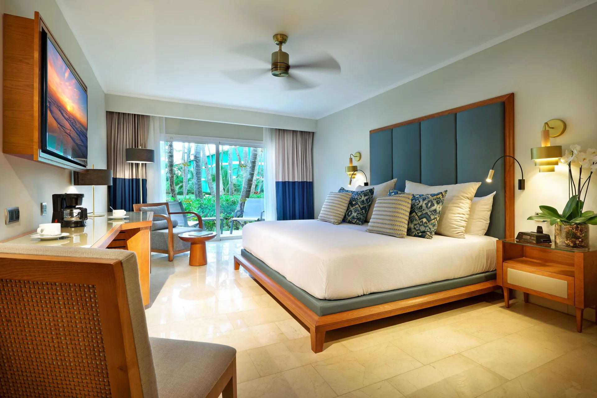 Junior Suite Poolside king bed facing sliding doors at Grand Palladium Punta Cana Resort & Spa.