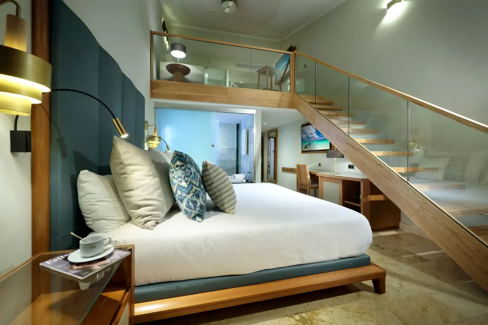 Loft Suite Garden View king bed and loft stairs at Grand Palladium Punta Cana Resort & Spa.