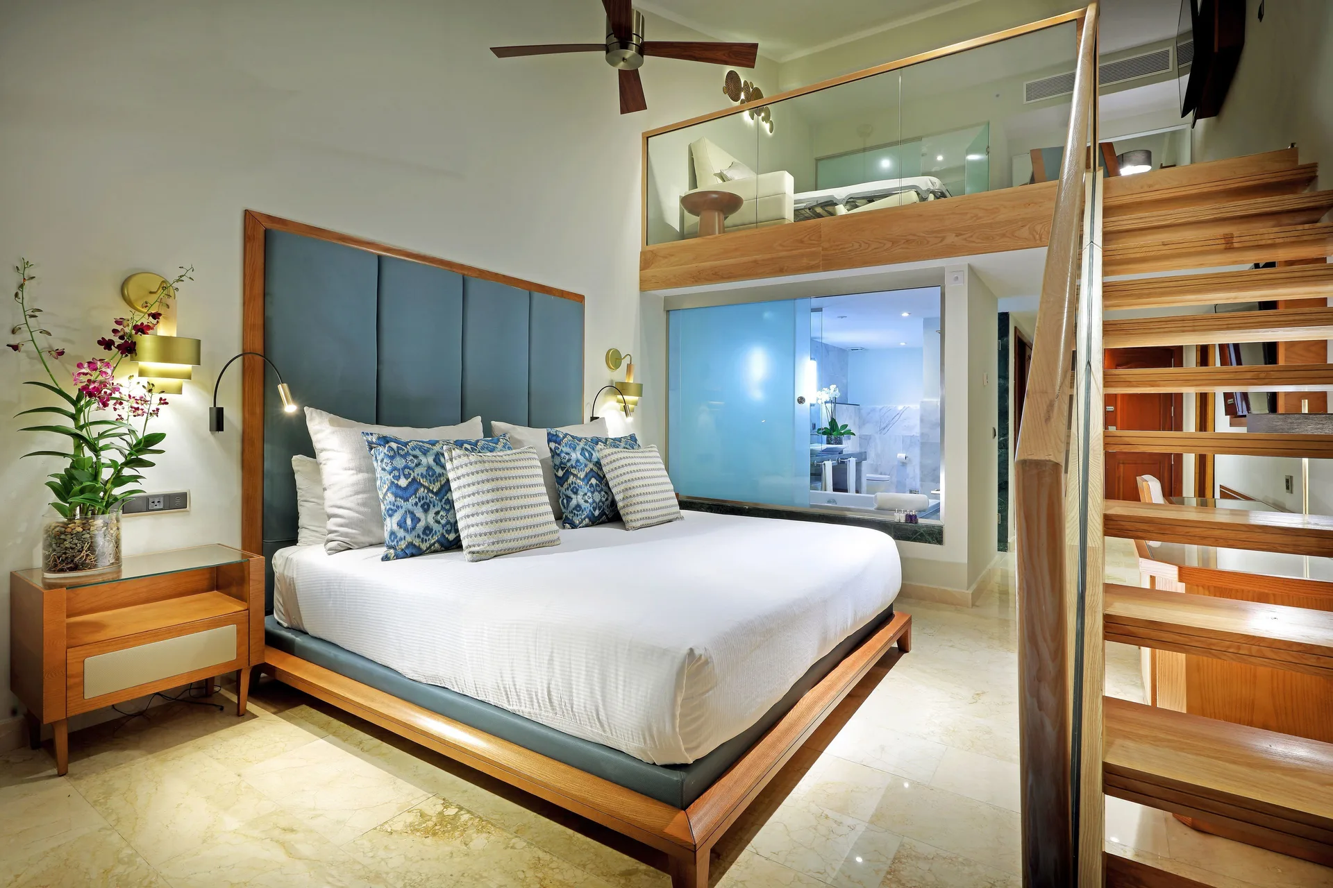 Loft Suite Garden View bedroom with king bed and stairs at Grand Palladium Punta Cana Resort & Spa.