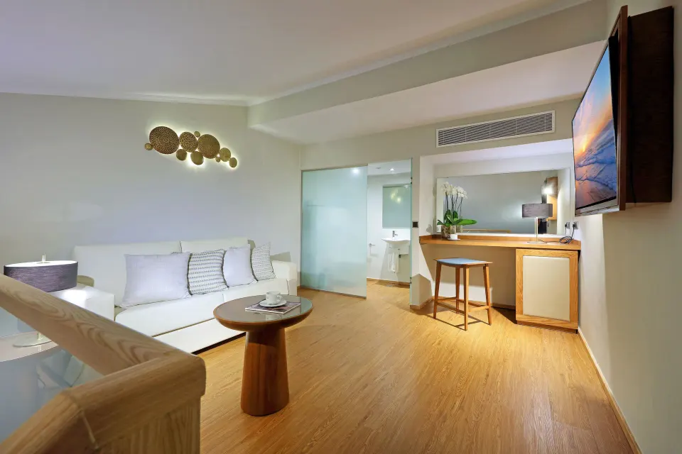 Loft Suite Garden View upper lounge with sofa and desk at Grand Palladium Punta Cana Resort & Spa.