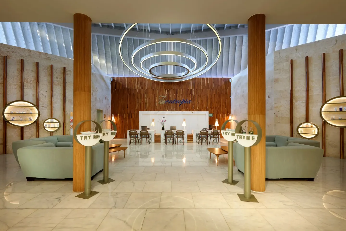 Spa reception lounge with circular lighting at Grand Palladium Select Bávaro.