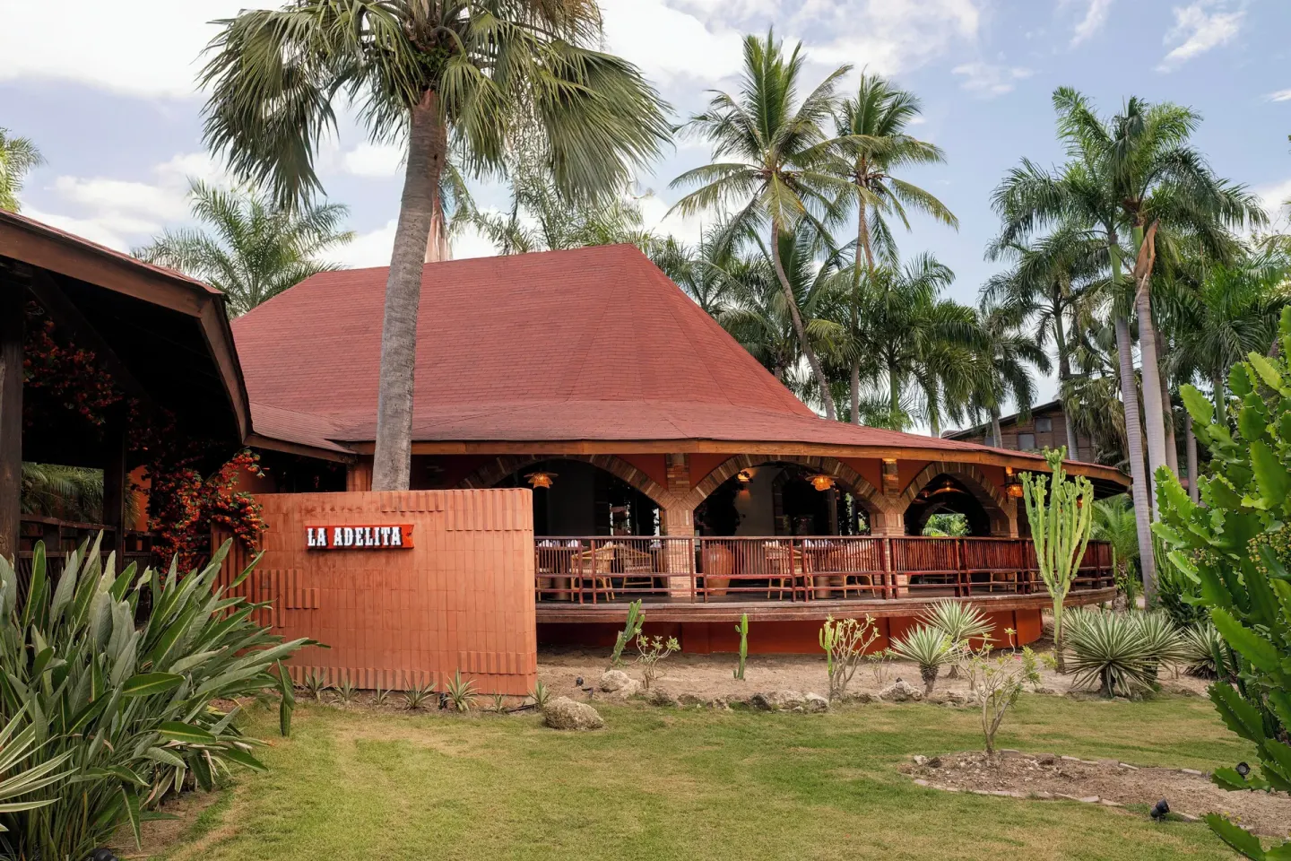 La Adelita restaurant exterior among palms at Grand Palladium Select Bávaro.
