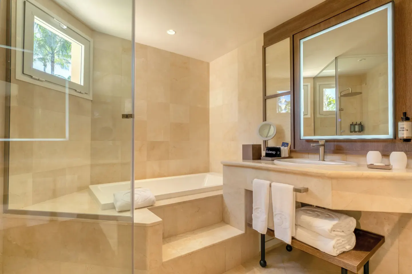 Junior Suite Garden View bathroom with tub and vanity at Grand Palladium Select Bávaro.