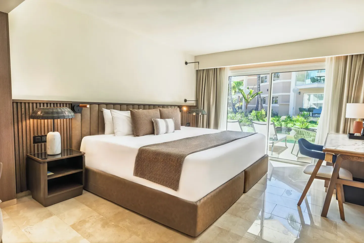 Junior Suite Garden View with king bed and patio at Grand Palladium Select Bávaro.