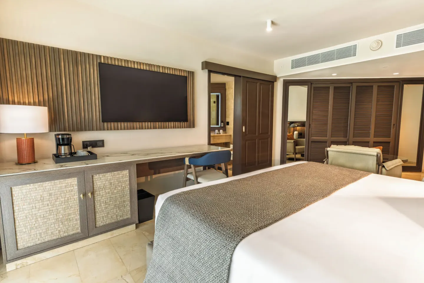 Junior Suite Garden View with king bed, TV wall and storage at Grand Palladium Select Bávaro.
