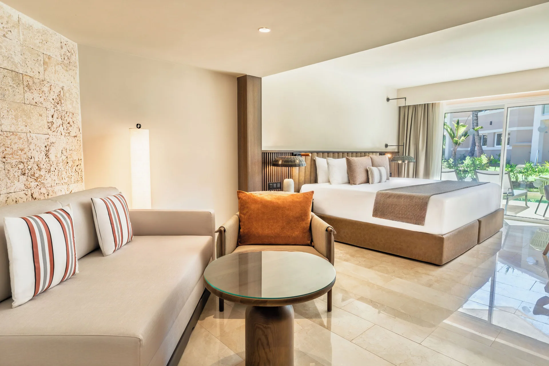 Premium Junior Suite Garden View with king bed and sitting area at Grand Palladium Select Bávaro.