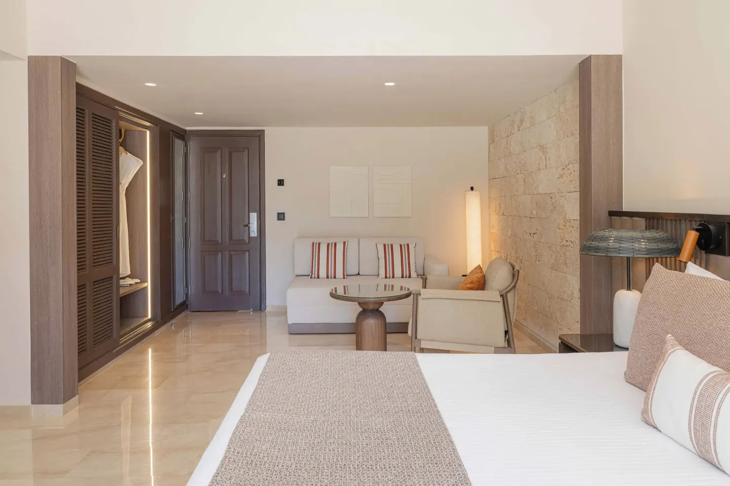 Romance Suite Garden View bed facing sitting area at Grand Palladium Select Bávaro.