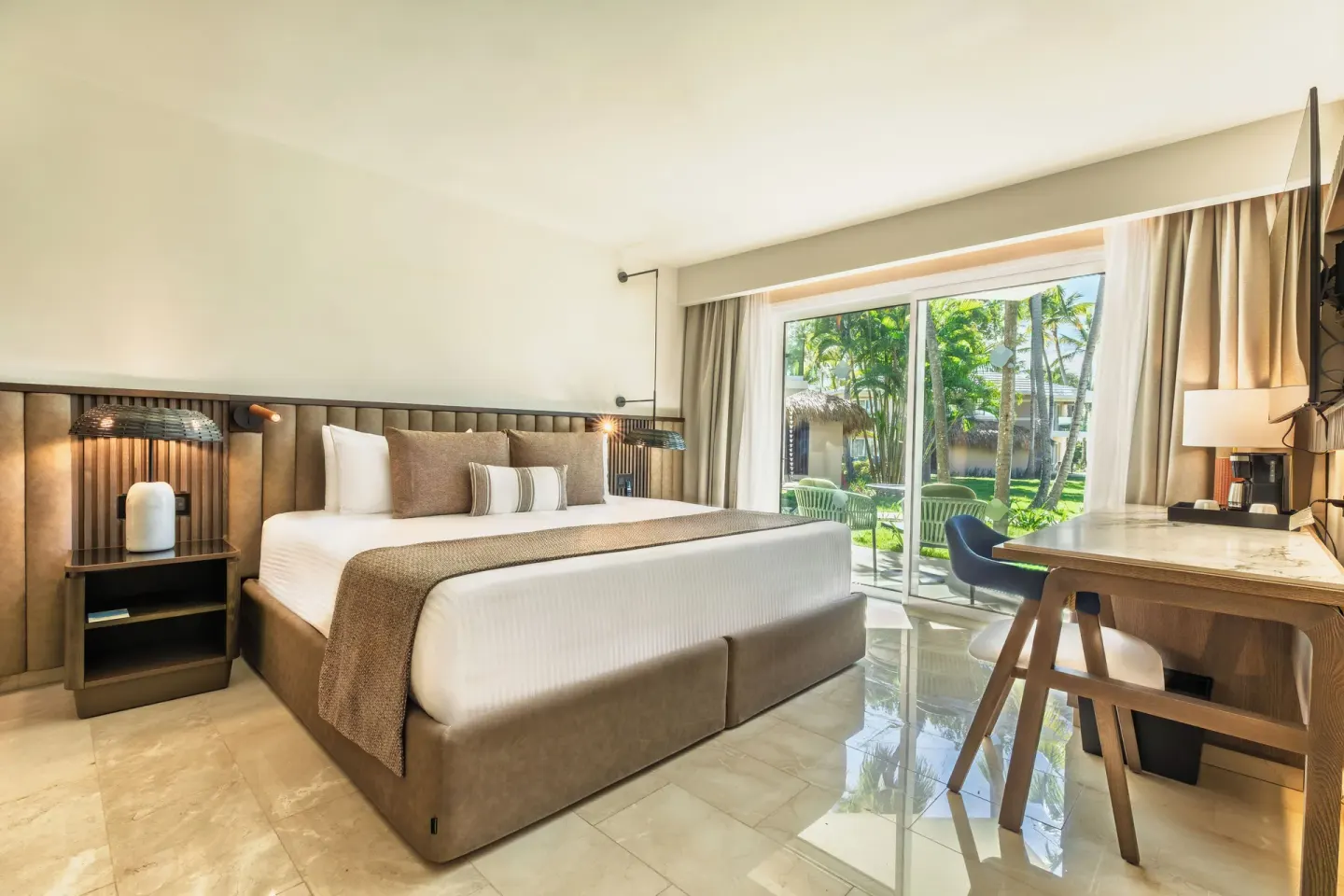 Romance Suite Garden View king bed and terrace at Grand Palladium Select Bávaro.