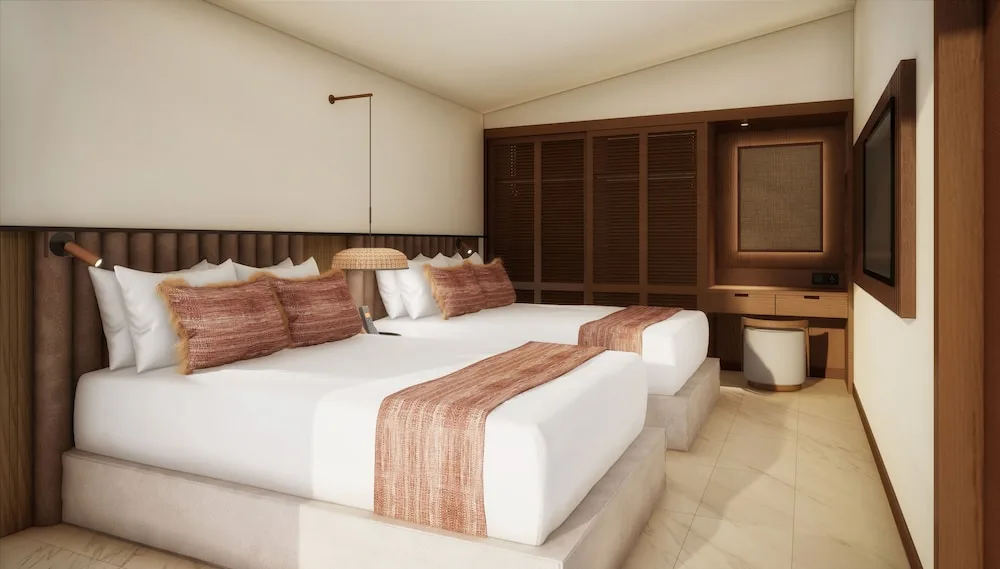 Junior Suite with two beds, desk, and wood wardrobes at Grand Palladium Select Bávaro.