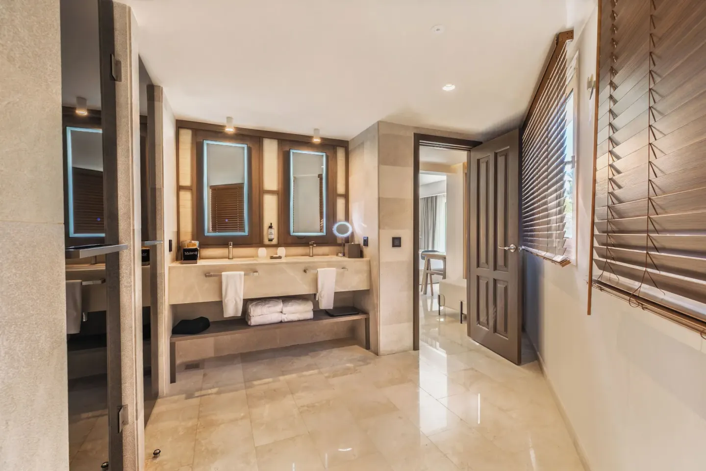 Superior Junior Suite Garden View bathroom at Grand Palladium Select Bávaro with double vanity and wood blinds.