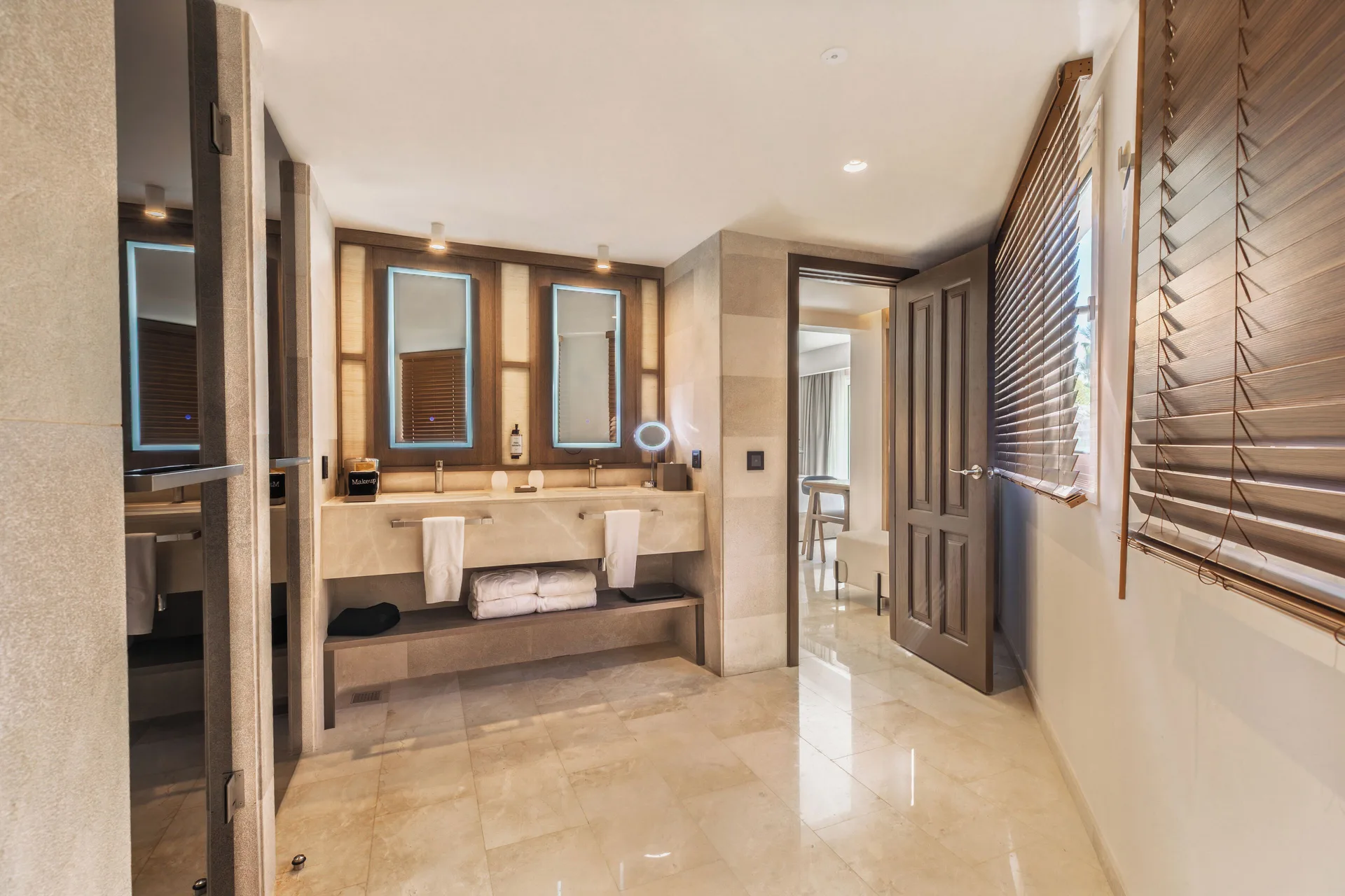 Superior Junior Suite Garden View bathroom at Grand Palladium Select Bávaro with double vanity and wood blinds.