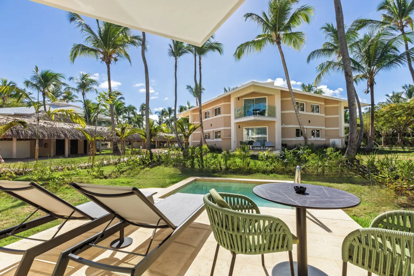 Superior Junior Suite private pool terrace at Grand Palladium Select Bávaro with loungers and garden view.