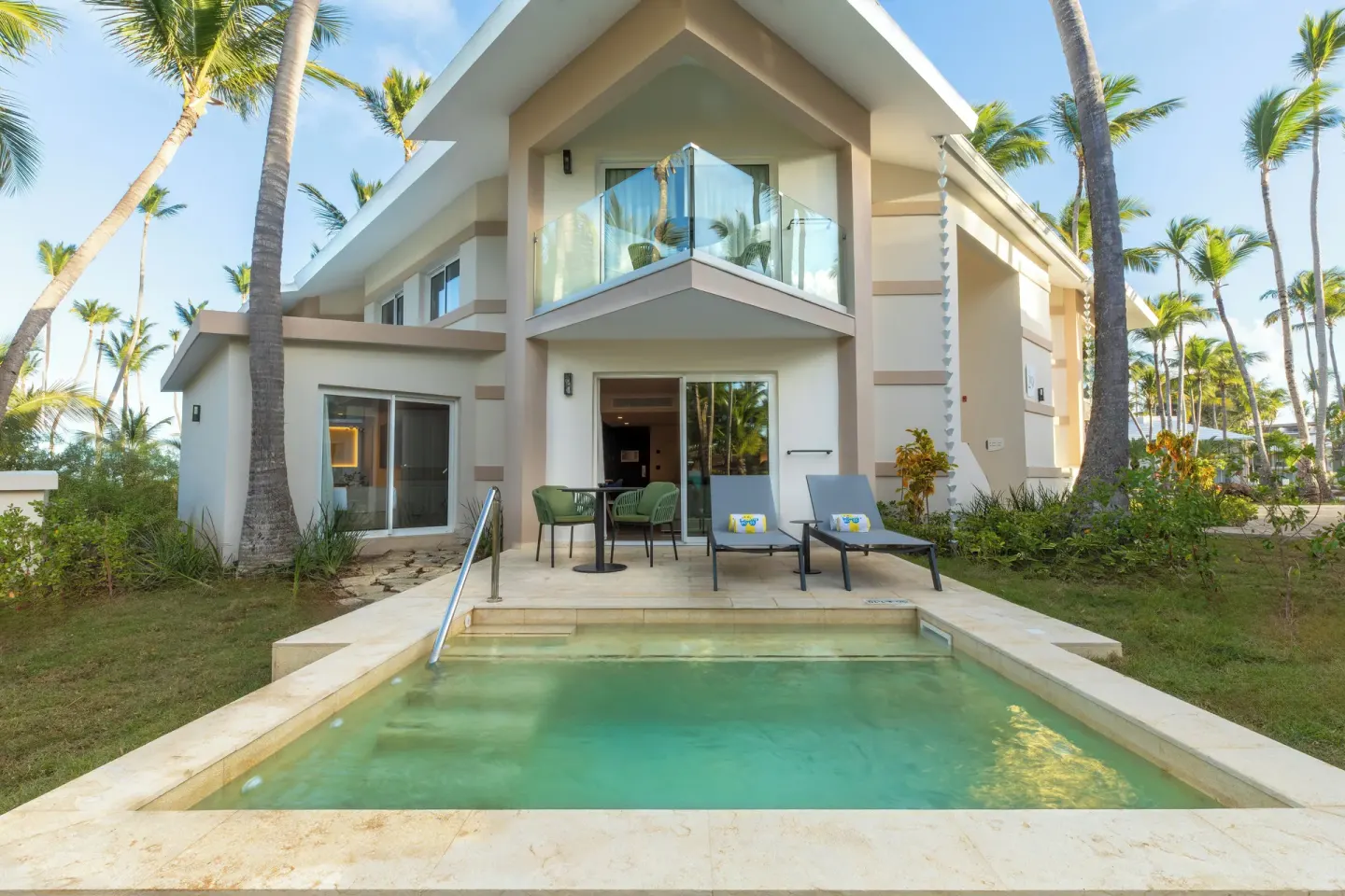 Superior Junior Suite private pool at Grand Palladium Select Bávaro in front of a two-story villa building.