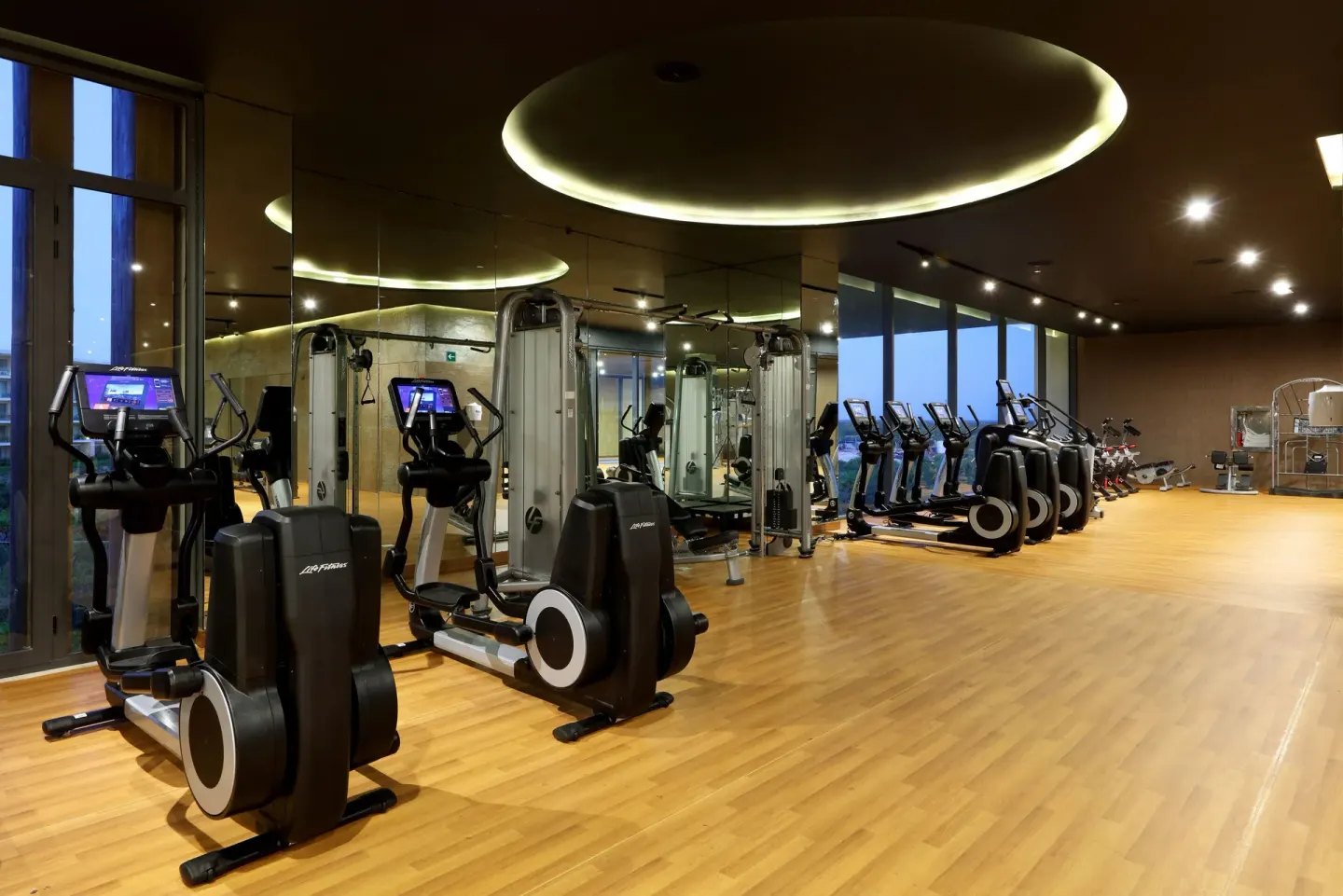 Cardio machines line a mirrored gym at Grand Palladium Select Costa Mujeres.