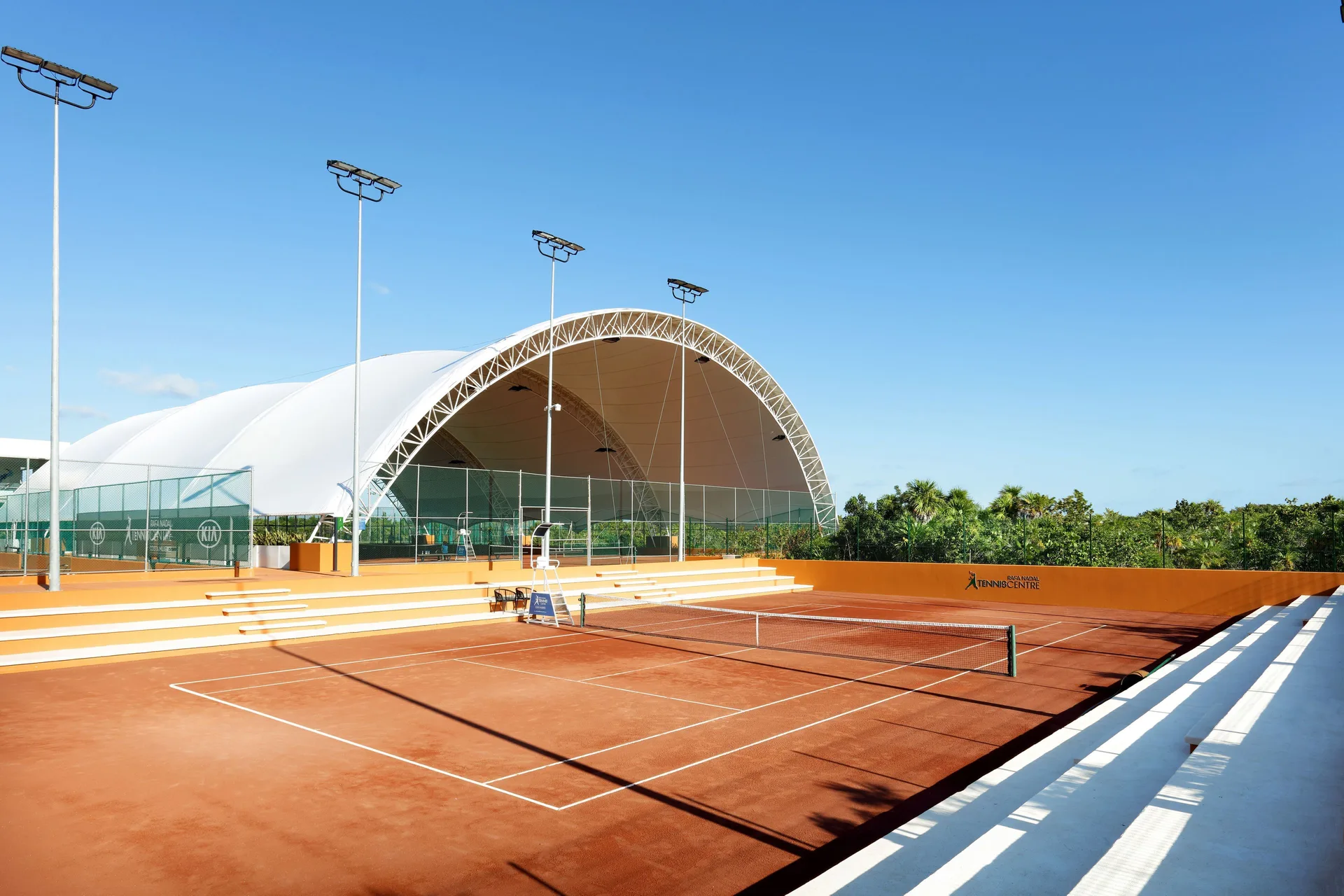 Clay show court with covered seating at Grand Palladium Select Costa Mujeres.