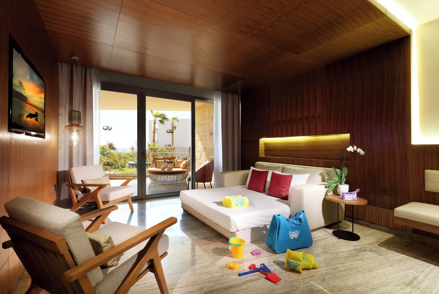 Family lounge area with daybed and terrace at Grand Palladium Select Costa Mujeres.