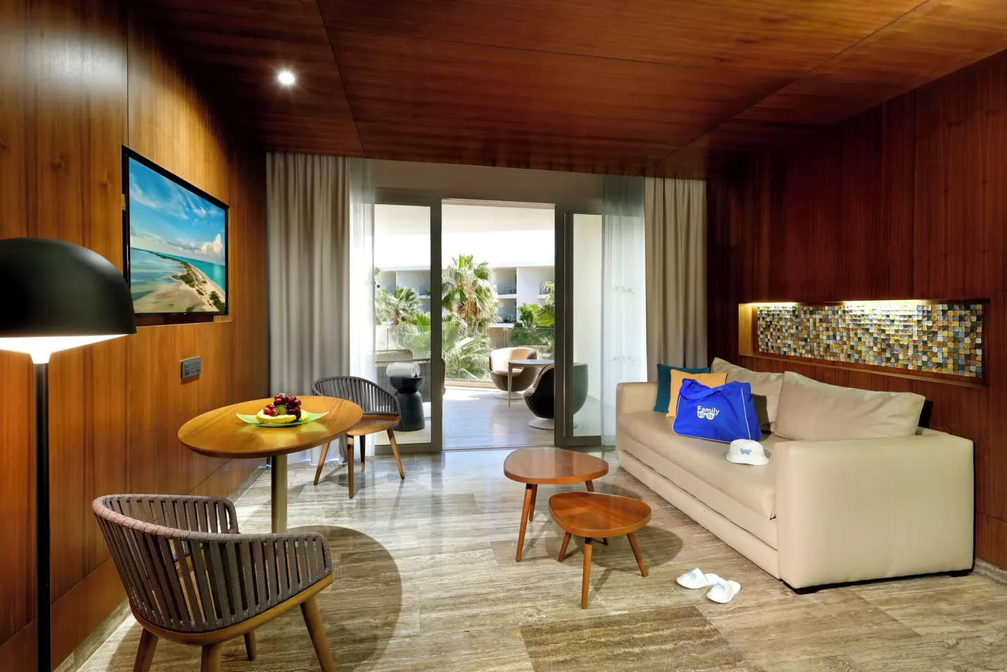 Guest room sitting area with sofa at Grand Palladium Select Costa Mujeres.