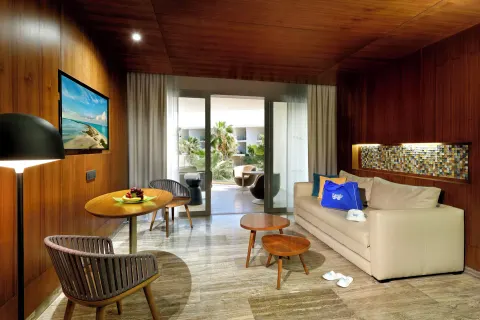 Guest room sitting area with sofa at Grand Palladium Select Costa Mujeres.
