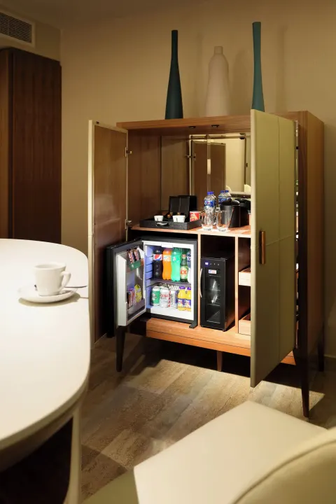 In-room minibar cabinet at Grand Palladium Select Costa Mujeres.