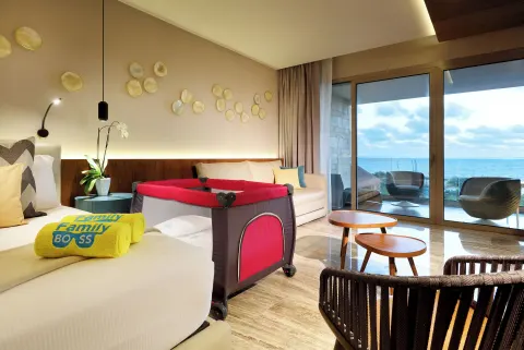 Ocean-view guest room with crib at Grand Palladium Select Costa Mujeres.