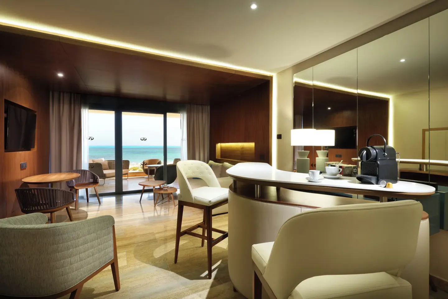 Ocean-view suite living area with bar seating at Grand Palladium Select Costa Mujeres.
