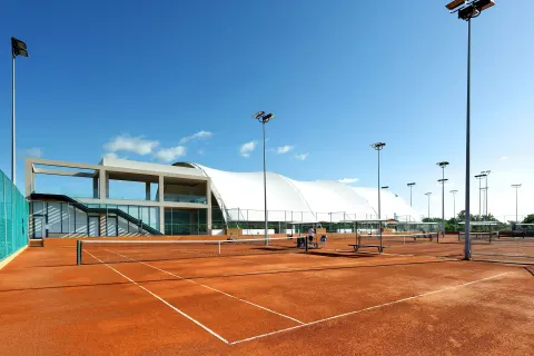 Outdoor clay tennis courts at Grand Palladium Select Costa Mujeres.