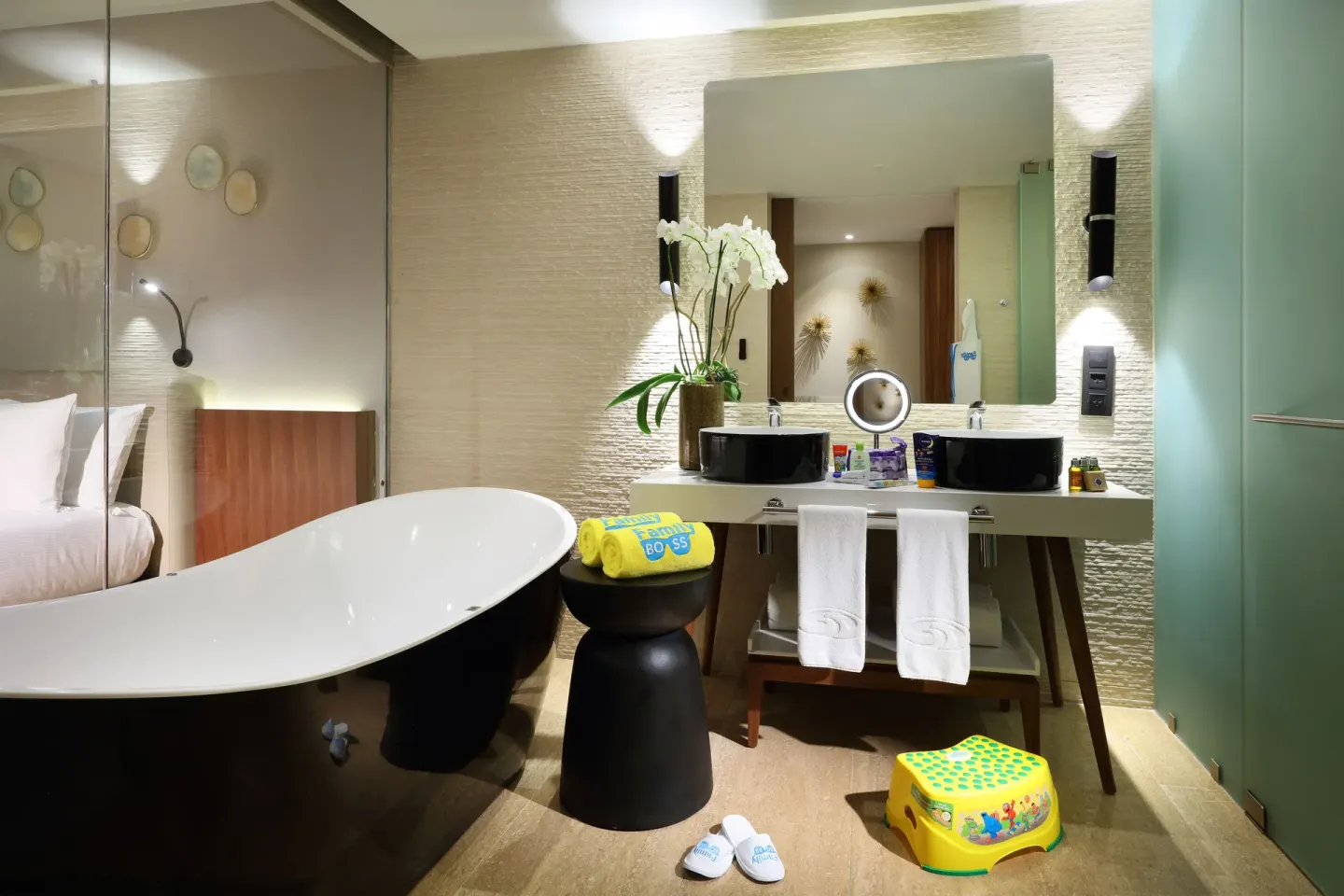Wide bathroom view with tub, twin sinks and glass shower at Grand Palladium Select Costa Mujeres.