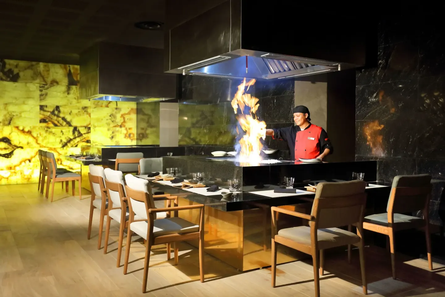 Chef cooking with flames at a teppanyaki grill at Grand Palladium Select Costa Mujeres.