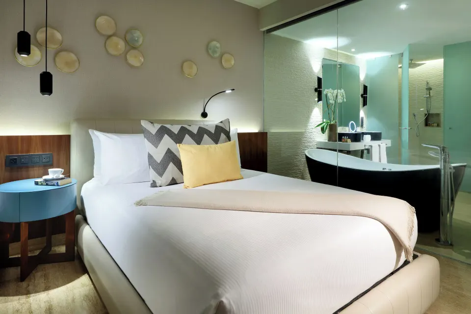 Junior Suite Pool Access bed and freestanding tub at Grand Palladium Select Costa Mujeres.