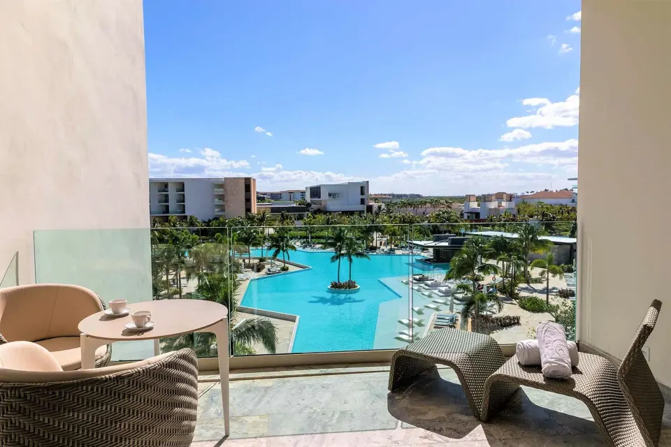 Junior Suite Poolside terrace with loungers overlooking the pool at Grand Palladium Select Costa Mujeres.