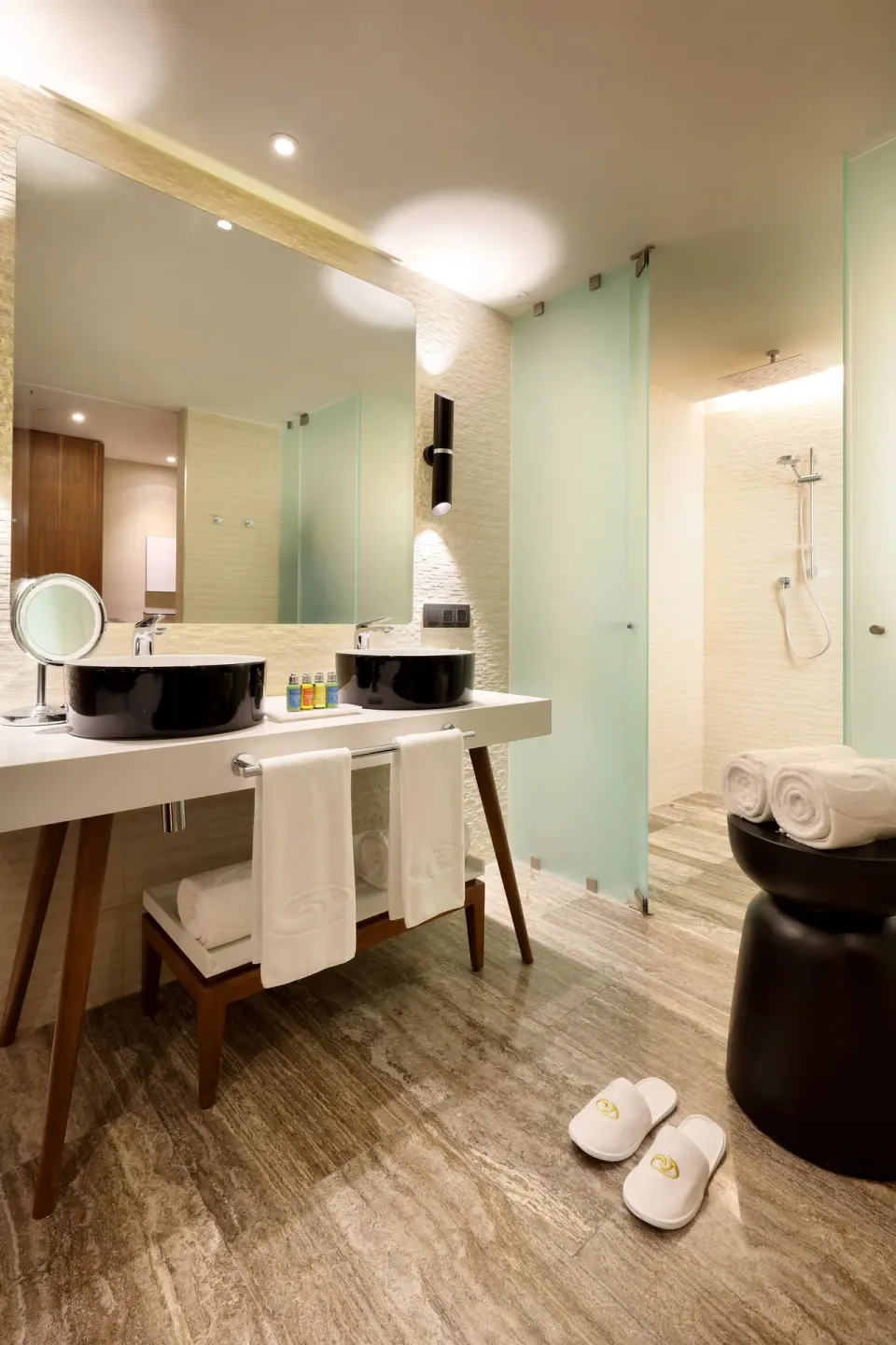 Junior Suite bathroom with double sinks and glass shower at Grand Palladium Select Costa Mujeres.