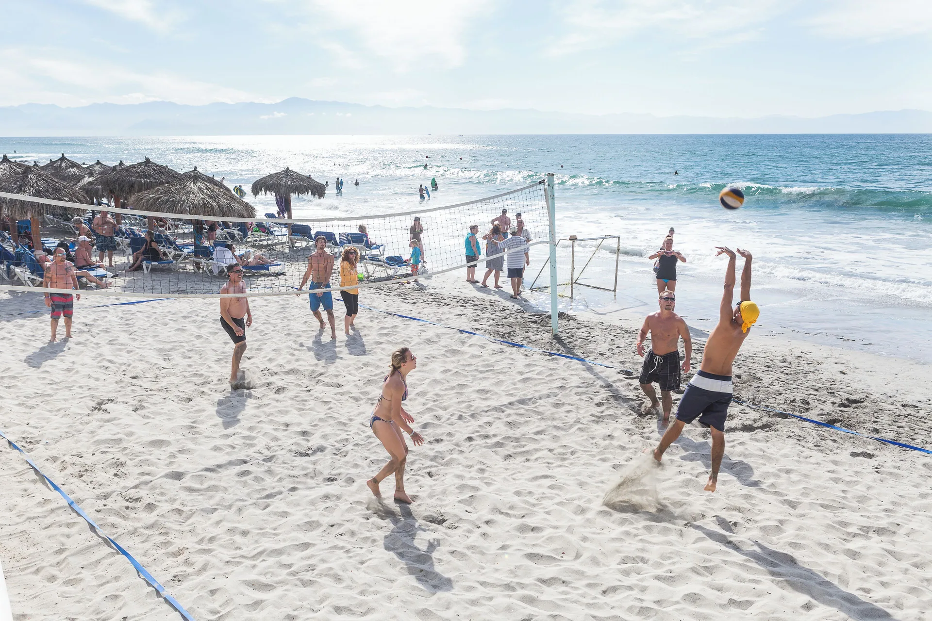 Beach volleyball game by the ocean at Grand Palladium Vallarta Resort & Spa.