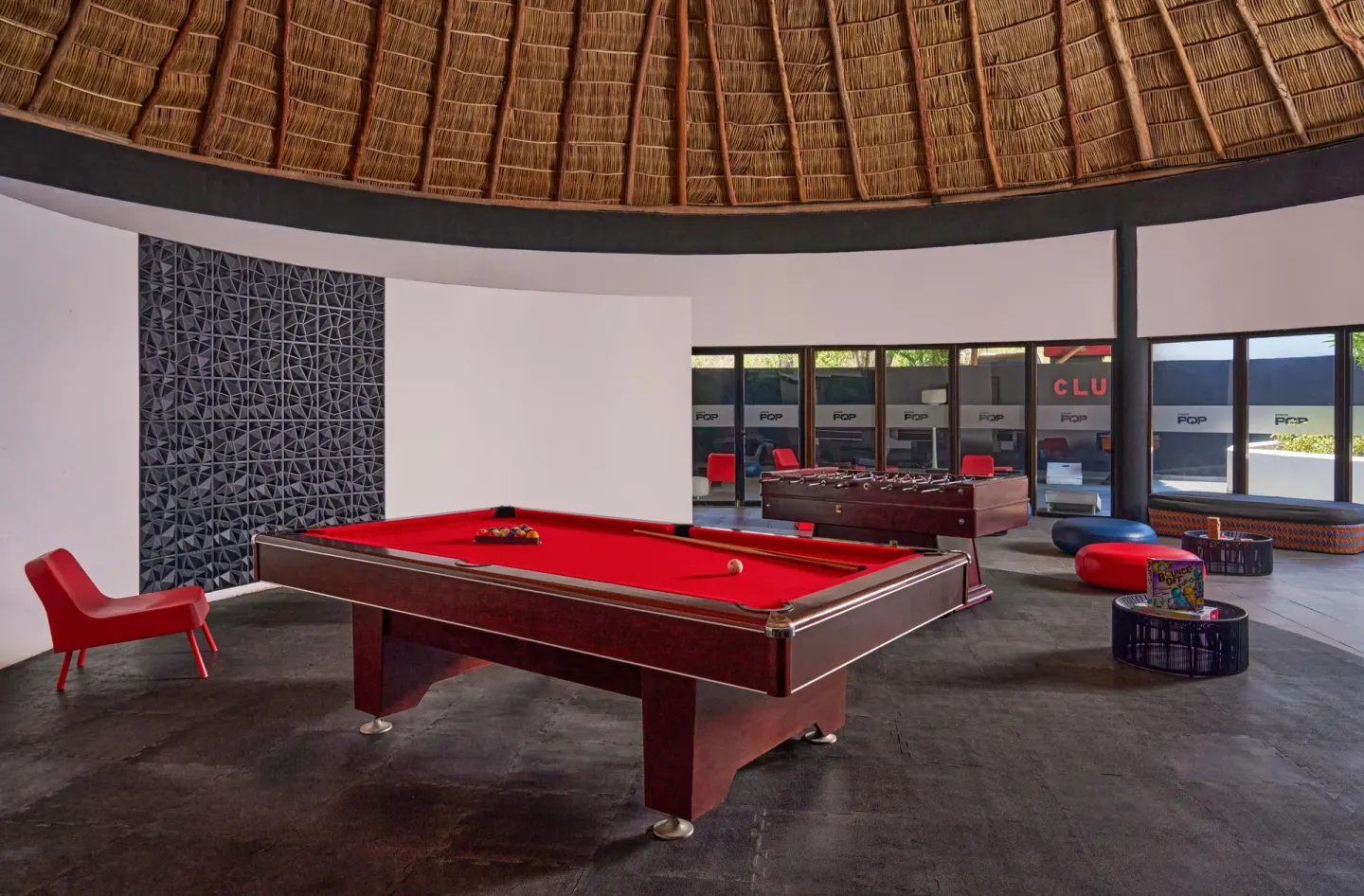 Game room with red pool table and foosball at Grand Palladium Vallarta Resort & Spa.