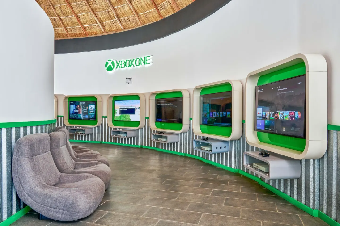 Gaming lounge with wall-mounted console stations at Grand Palladium Vallarta Resort & Spa.
