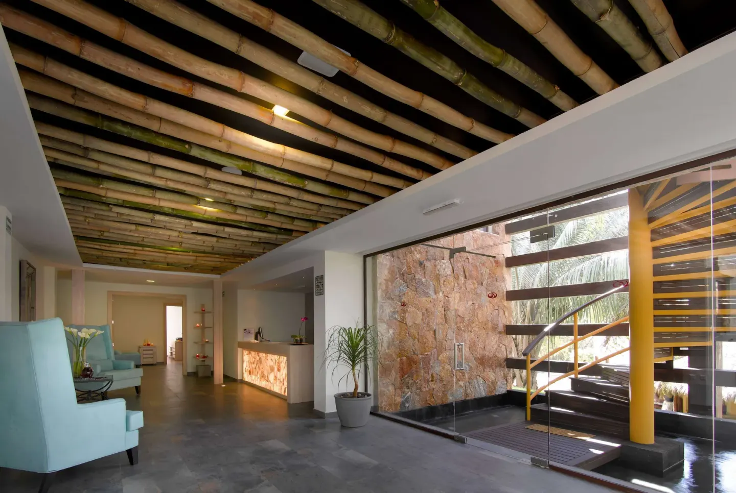 Lobby corridor with bamboo ceiling and glass stairwell at Grand Palladium Vallarta Resort & Spa.