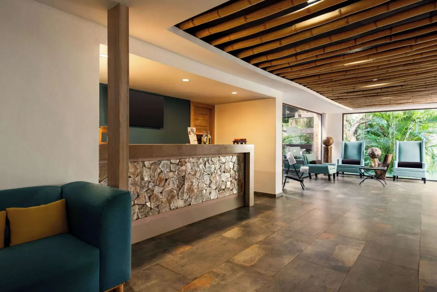 Lobby seating and stone-front desk at Grand Palladium Vallarta Resort & Spa.