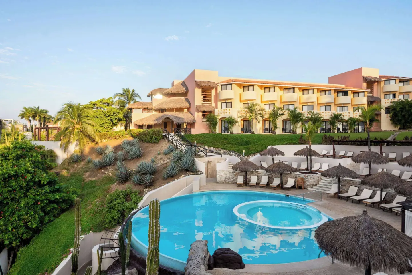 Resort pool, loungers and guest buildings at Grand Palladium Vallarta Resort & Spa.