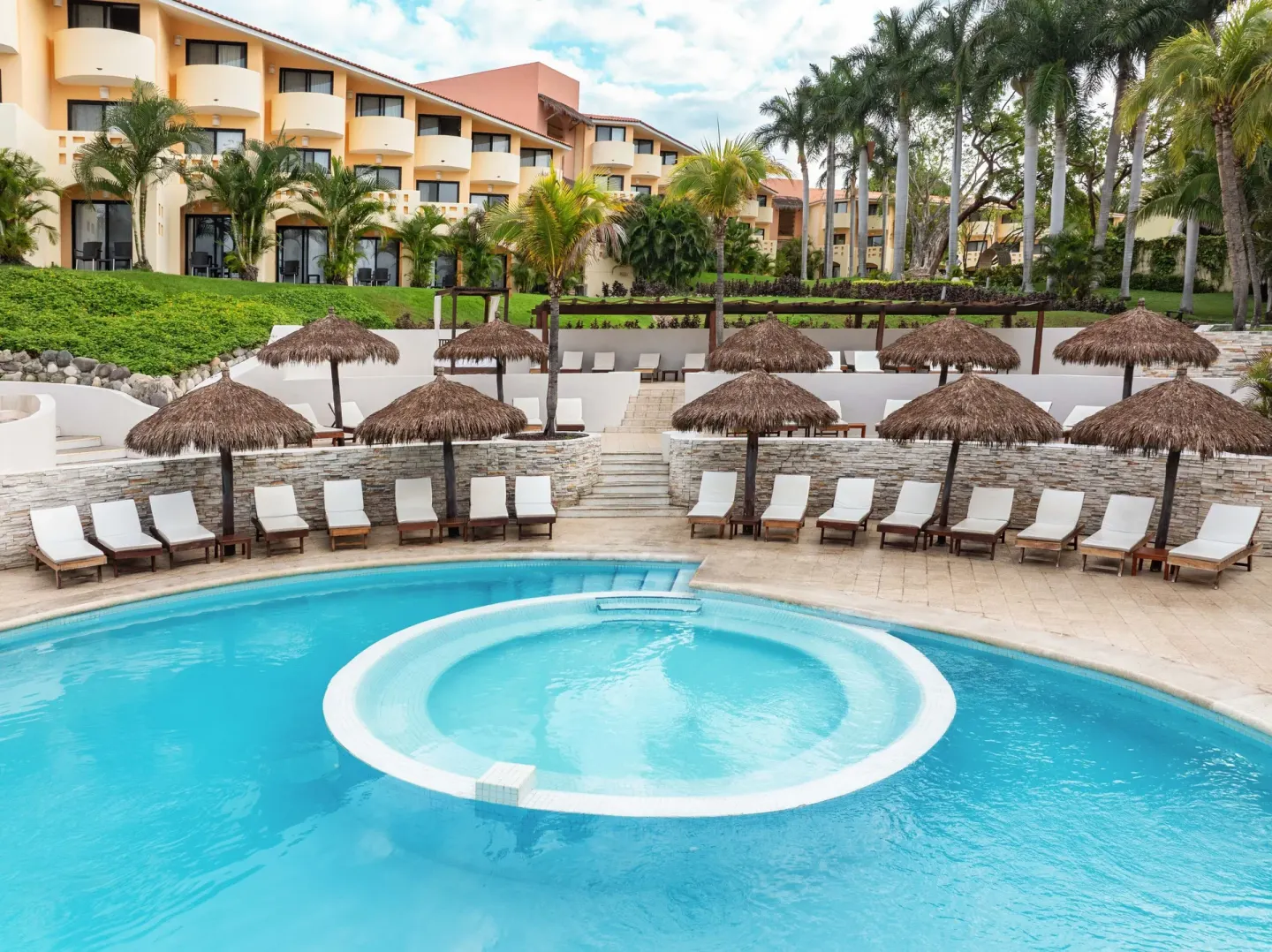 Pool with circular shallow area and loungers at Grand Palladium Vallarta Resort & Spa.