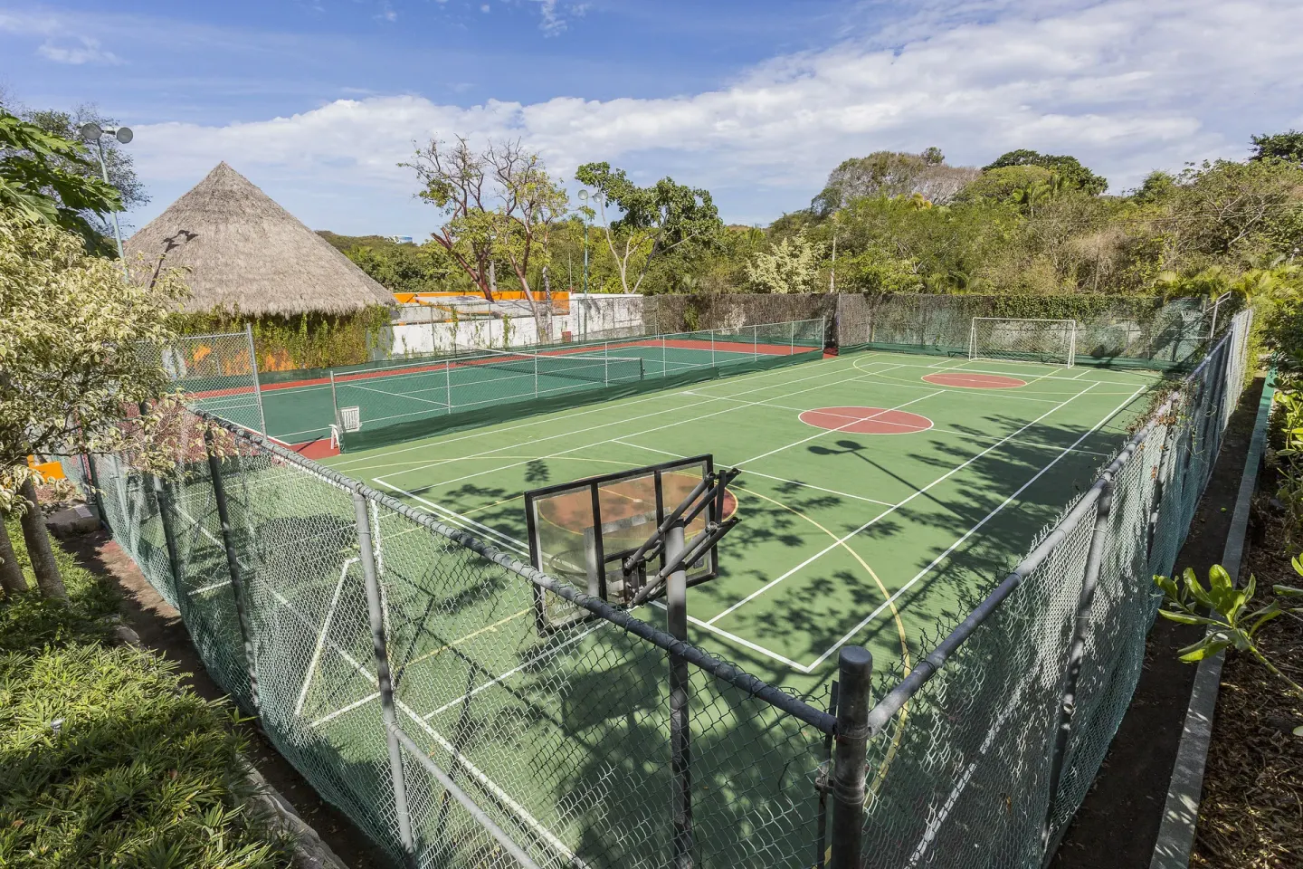Fenced sports courts for basketball and tennis at Grand Palladium Vallarta Resort & Spa.