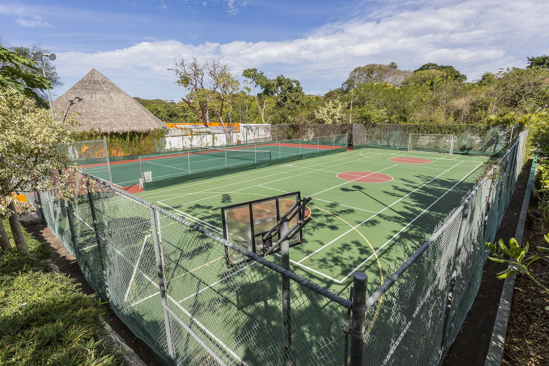 Fenced sports courts for basketball and tennis at Grand Palladium Vallarta Resort & Spa.