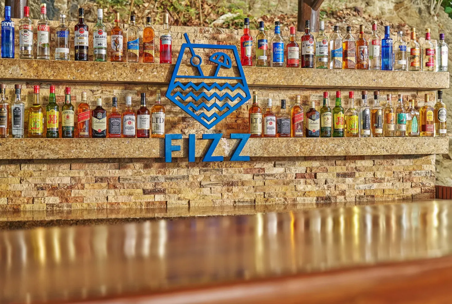 Fizz bar back wall with bottles and blue sign at Grand Palladium Vallarta Resort & Spa.