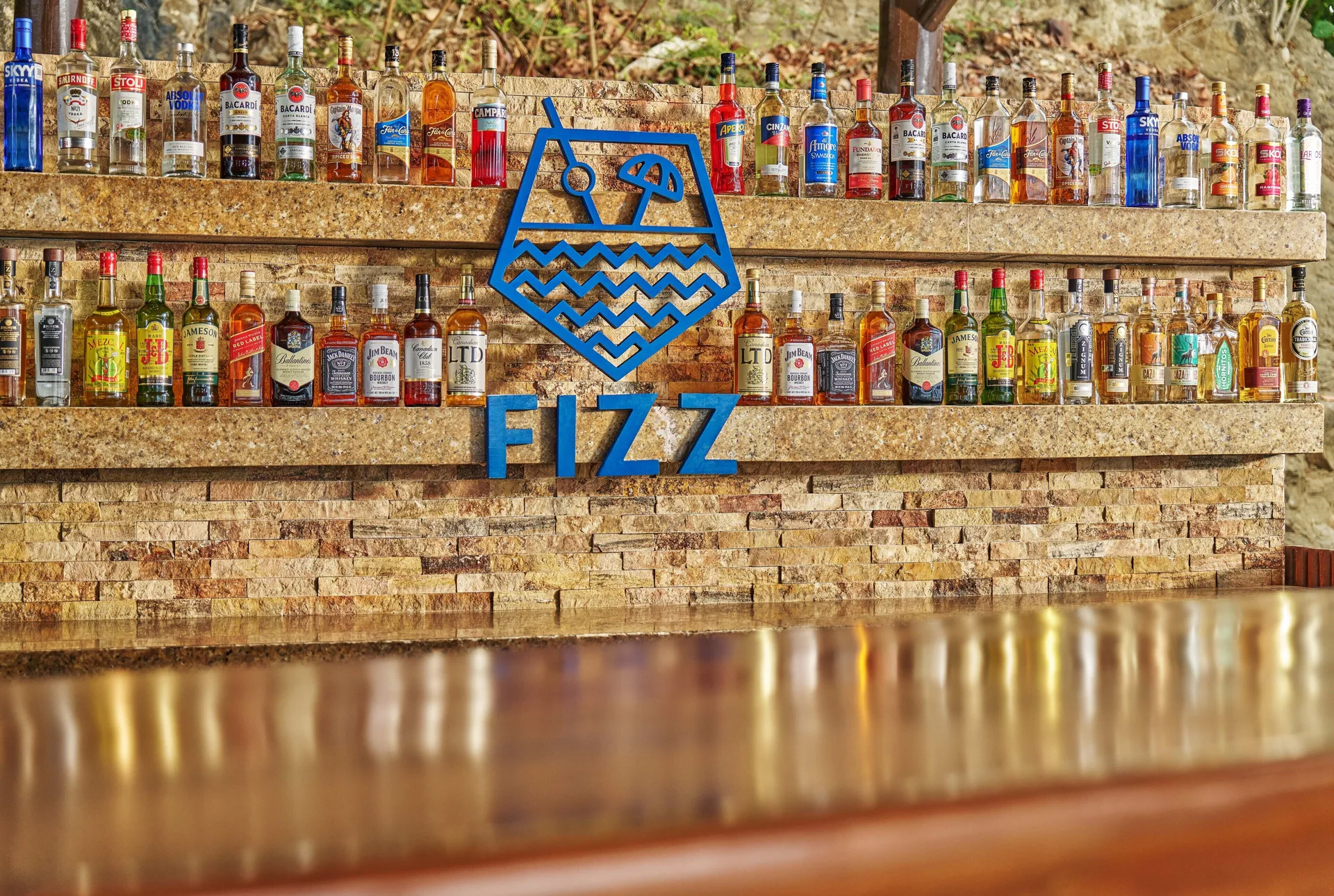 Fizz bar back wall with bottles and blue sign at Grand Palladium Vallarta Resort & Spa.