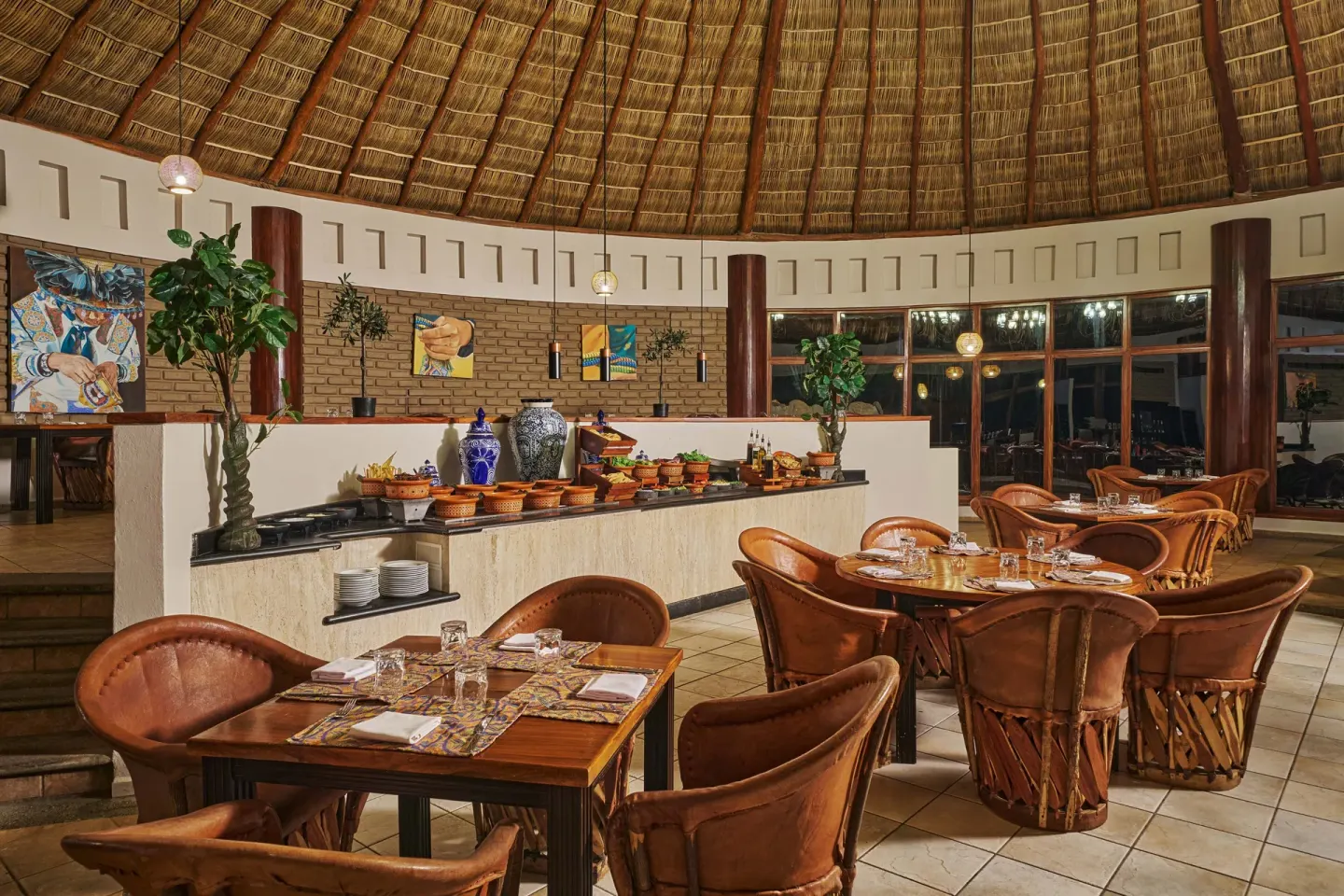 Mexican restaurant dining room with buffet and leather chairs at Grand Palladium Vallarta Resort & Spa.