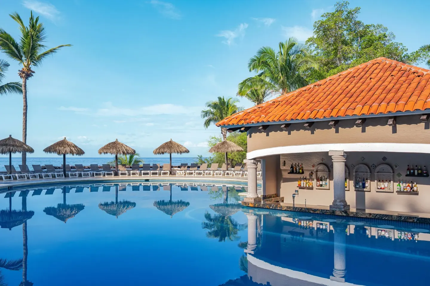 Pool bar with ocean backdrop at Grand Palladium Vallarta Resort & Spa.