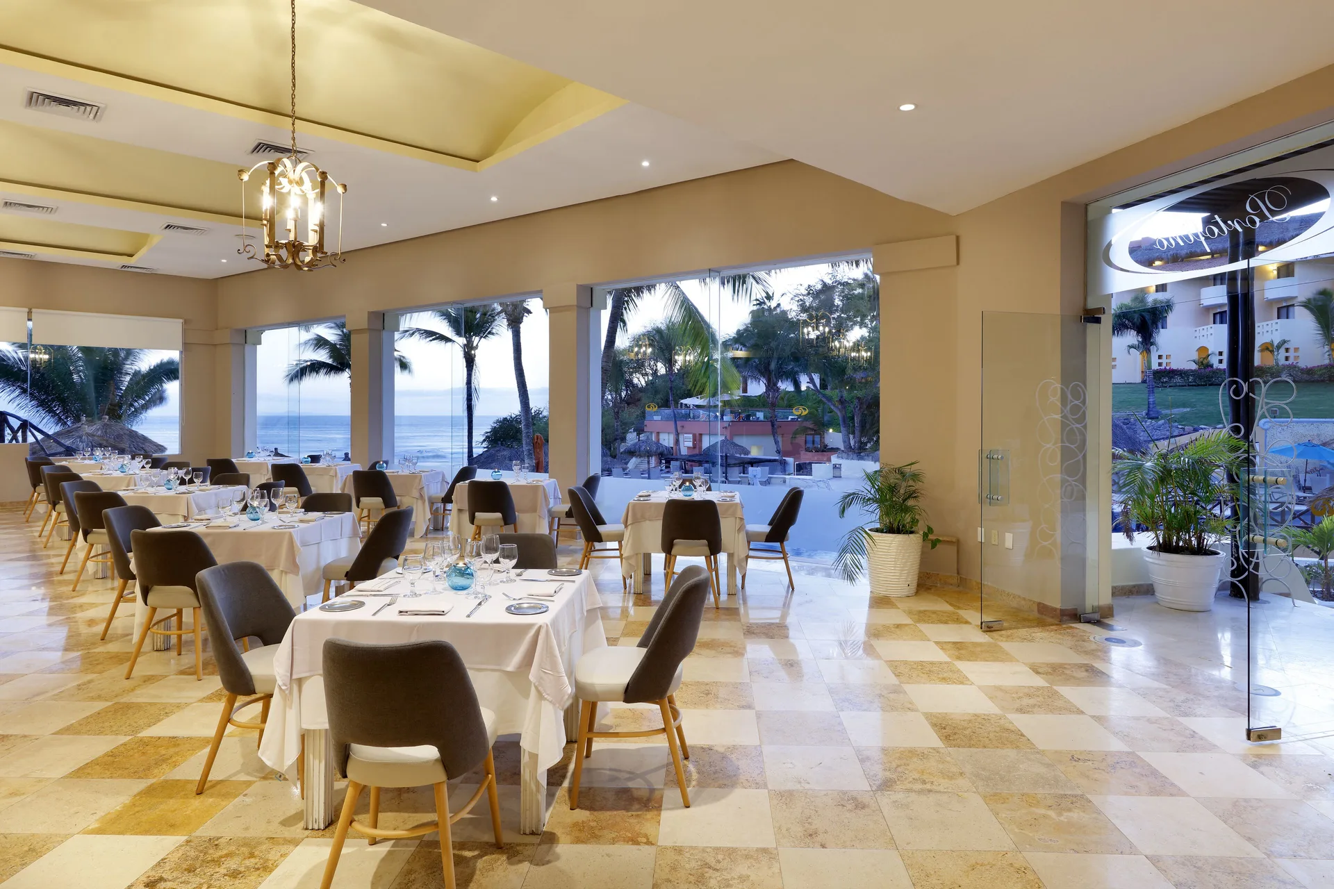 Portofino dining room with ocean-view windows at Grand Palladium Vallarta Resort & Spa.